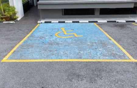 View of an old disabled car park in a parking lotの写真素材