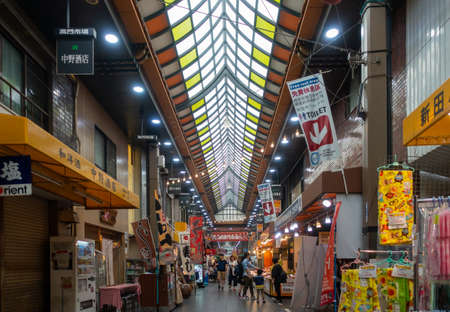 Walking view of Sennichimae Doguyasuji Shopping Street in Osaka. It is a very popular and famous shopping street  or shotengai amongst tourists in Japanのeditorial素材