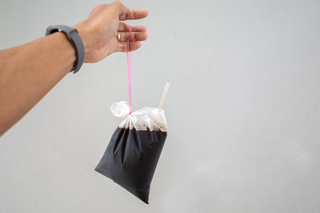 A Malaysian style take away black coffee drink in a plastic packet, tied by the side. Technique used by local coffee shops.の写真素材