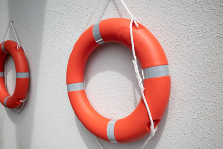 Two inflated life buoy hanging on the wallの写真素材