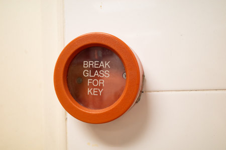 A red colored emergency break glass panel in case of a fire emergency. It is installed in all buildingsの写真素材
