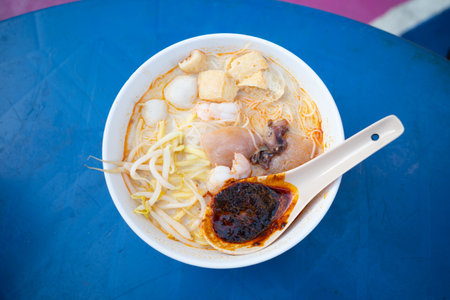 A bowl of  Curry Mee which is a noodle dish with curry broth popular in Malaysiaの写真素材