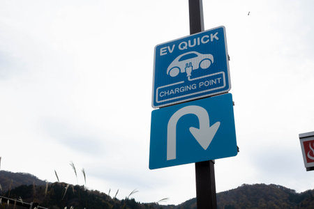 Signages of a EV Quick Charging point and a U turn in a parking lot in Japanの写真素材