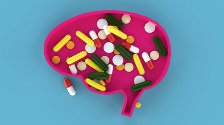 Assorted medical pills and human brain with blue background in conceptual format. Showing the brain...