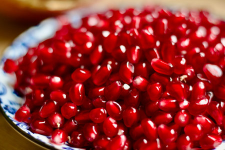 Fresh pomegranate seeds on a plate closeupの写真素材