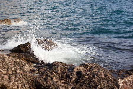 Sea waves breaking on the rocks on the coastの写真素材