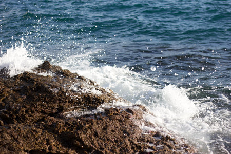 Sea wave splashing on the rocks. Close-up view.の写真素材