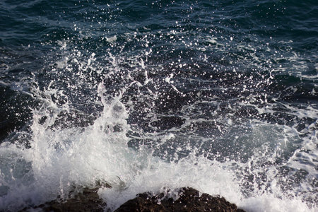 Waves splashing on the rocky shore of the Mediterranean Sea.の写真素材