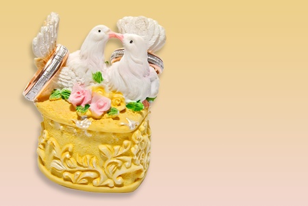 wedding invitation or card form with two kissing pigeons on the rings box over yellow-pink gradient backgroundの写真素材