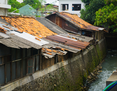 Slums near dirty ditch photo taken in Jakarta Indonesiaの写真素材