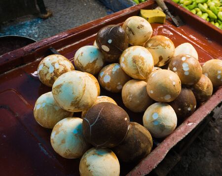 Peeled coconuts sold on a wood box photo taken in Bogor Indonesia