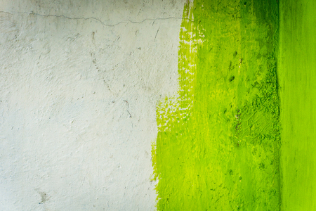 unfinished painted paint wall with green color and white photo taken in jakarta indonesiaの写真素材