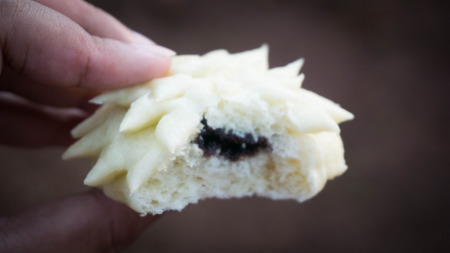 a bitten bakpao hand holding close up photo taken in pekalongan asia indonesia