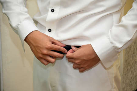 puts on belt