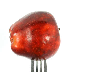 Fork with a red appleの写真素材