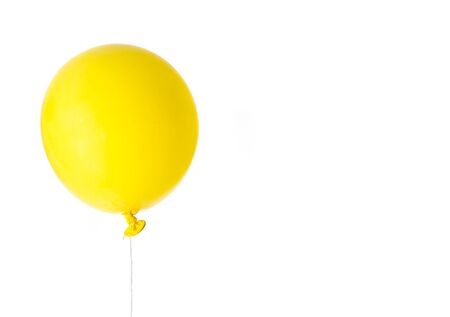 Yellow balloon inflated isolated on white backgroundの写真素材