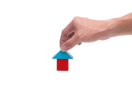 Hand and house block isolated on white backgroundの写真素材
