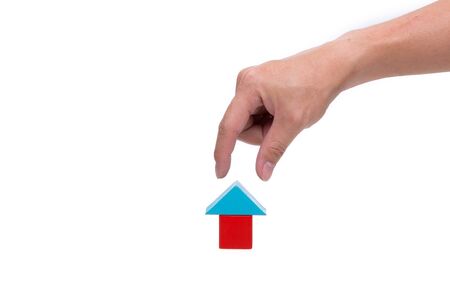Hand and house block isolated on white backgroundの写真素材