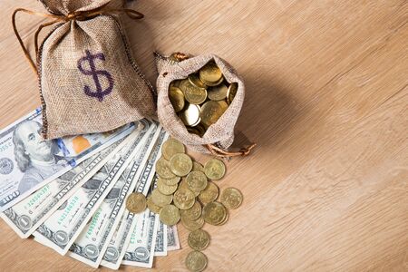 Financial concept. Money and coins on wooden backgroundの写真素材