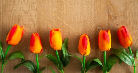 Tulips bunch on wooden background. Space for text.の写真素材