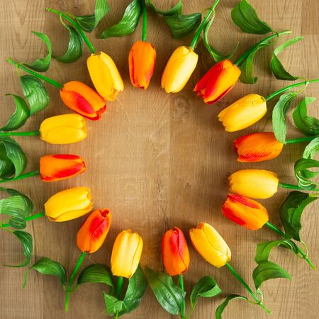 Tulips bunch on wooden background. Space for text.の写真素材