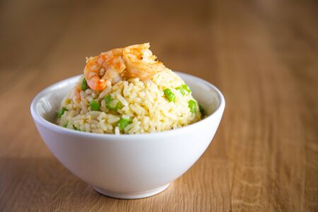 shrimp fried rice on wooden backgroundの写真素材