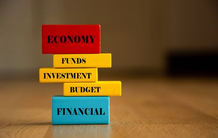 Invest conceptual word on wooden blockの写真素材