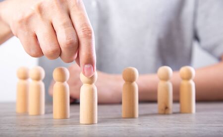 Successful team leader, businessman hand choose people standing out from the crown.の写真素材