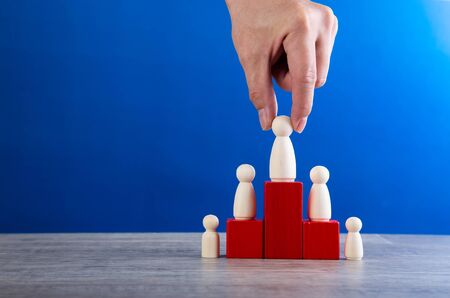 successful team leader, businessman hand choose people standing out from the crown.の写真素材