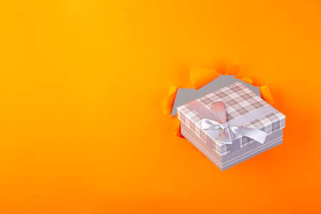 present through a orange torn paper