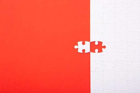 Blank white puzzle pieces on red background, flat lay. Space for textの写真素材
