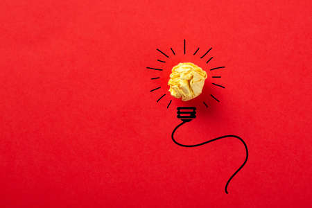 Creative idea, Inspiration, New idea and Innovation concept with Crumpled Paper light bulb on red background.の写真素材