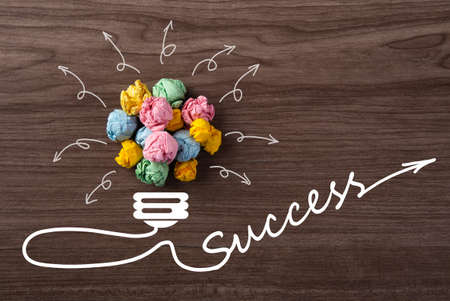 New good ideas, Paper Ball of lightbulb shape with success word on wooden backgroundの写真素材