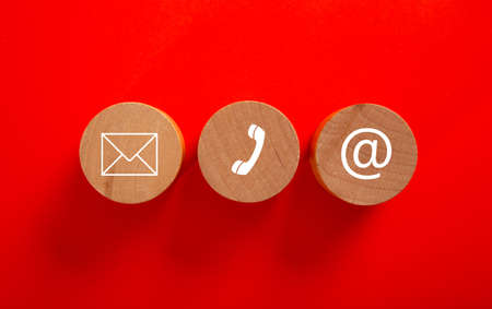 Wooden block with symbol telephone, email and address. Conceptual of contact us and e-mail marketing...