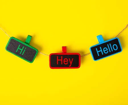 Color tag with the word HI, HEY and HELLO on yellow backgroundの写真素材