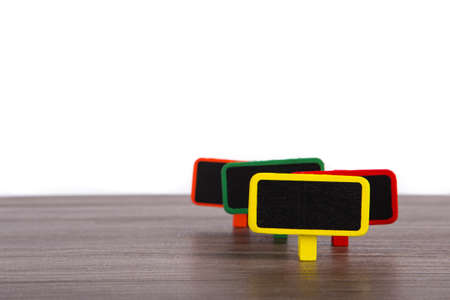 A blank wooden tag on table with white backgroundの写真素材