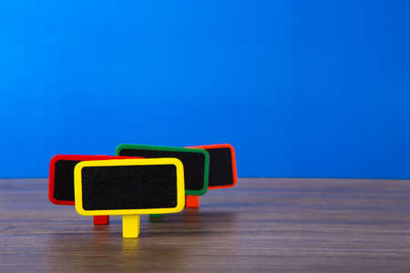 A blank wooden tag on table with blue backgroundの写真素材