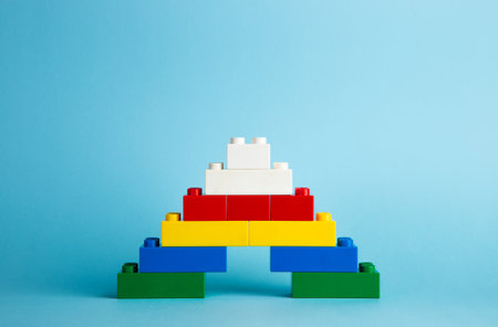 Plastic building blocks on red backgroundの写真素材