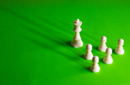 Concept of business leadership as a group of chess pieces gathering together as a teamの写真素材