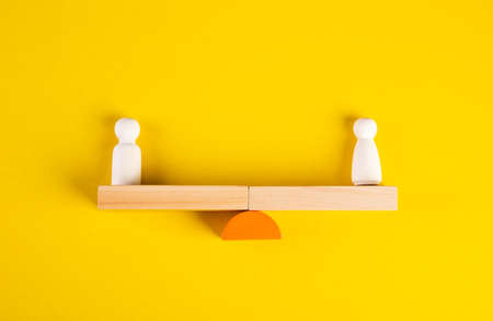 Gender Equality Concept. Male And Female Balancing On Seesaw
