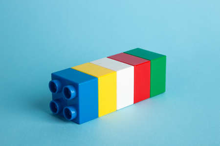 Plastic building blocks on blue background