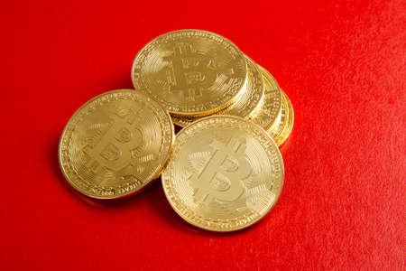 close up on bitcoin on red backgroundの写真素材