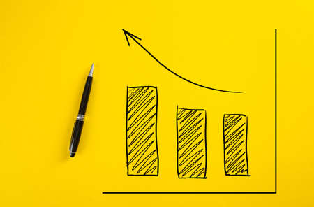 Statistical hand drawn financial graph predicting an economic financial growth or improvement on yellow background.の写真素材