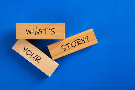 What's Your Story word on wooden block on blue backgroundの写真素材