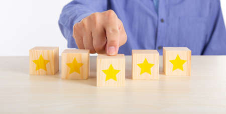 The best excellent business services rating customer experience concept. Hand touching wooden cube...