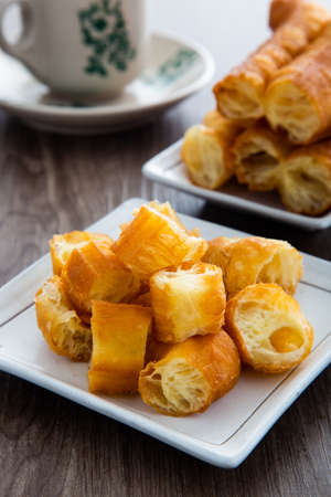 Youtiao (Chinese fried breadstick). Long golden brown deep fried dough strip.の写真素材