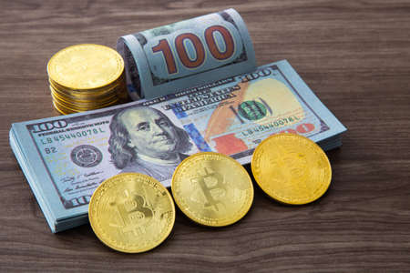 US Dollar bills stack on wooden table