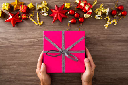 Christmas composition. Christmas gifts, decorations on wooden background. Flat lay, top view. Copy...