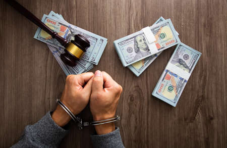 Money and handcuffs. Concept for corruption, fraud, money laundryの写真素材