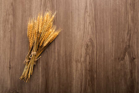 Spikelets of wheat on old wooden table